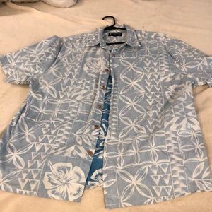 A casual button down short sleeve blue shirt with design